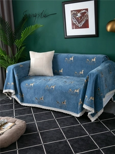 Detail of blue chenille sofa cover showing golden carriage print and white lace trim
