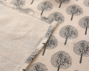 Macro view of cotton linen tablecloth showing stripe texture and hemmed edge detail