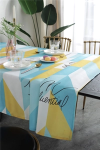 Detail of Nordic geometric triangle tablecloth with Influential print on dark wood