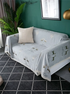 Detailed view of thick grey chenille sofa cover with deer pattern and lace edging