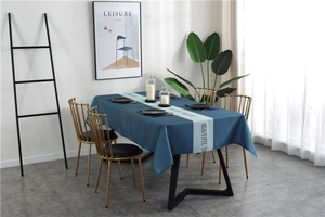 Detail of Nordic blue waterproof tablecloth with geometric pattern and table runner