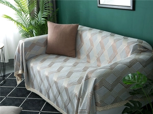 Detail of grey chenille sofa cover with rose gold geometric lines and lace edge