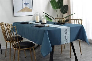 Close-up of waterproof navy tablecloth with Beautiful Table text and grey stripe