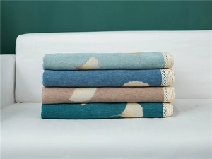 Detail of chenille sofa covers in four colors with ginkgo leaf pattern and lace trim