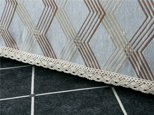 Detail of chenille sofa cover showing geometric patterns and white lace edges