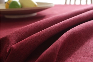 Close-up of dark red faux linen tablecloth showing thick texture and woven fabric detail