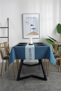 Close-up of waterproof Nordic geometric blue table runner with printed typography detail