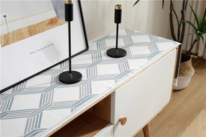 Detail of chenille cabinet runner with geometric patterns and fringe for home decor