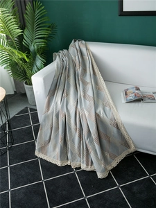 Detailed view of grey and coffee geometric chenille sofa cover with beige lace edges