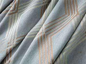 Close-up of thick chenille fabric with blue and orange geometric diamond patterns