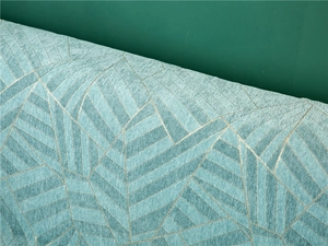 Detail of thick blue chenille sofa cover with golden geometric patterns and woven texture