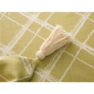 Modern minimalist green checkered tablecloth with decorative fringe and tassels
