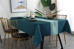 Detail of Nordic waterproof tablecloth featuring geometric mint green stripes on dark green fabric