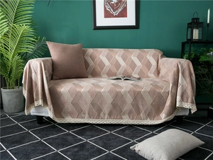 Detail of chenille sofa cover showing pink geometric weave and white lace edges