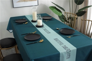 Detail of waterproof tablecloth with green geometric pattern and luxury matte texture
