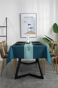 Close-up of waterproof geometric tablecloth with Nordic blue stripe and typography