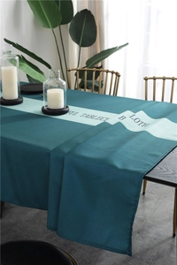 Detail of dark green waterproof tablecloth with decorative lettering and fine stitching