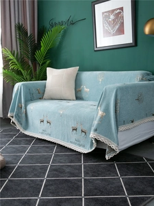 Detail of light blue chenille sofa cover with white lace edges and deer forest pattern