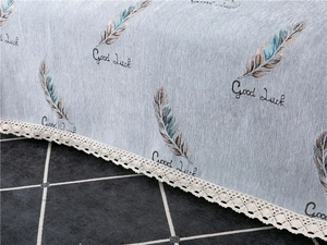 Close-up of thick chenille sofa cover with blue feather pattern and white lace edge