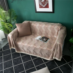 Close-up of chenille sofa cover with geometric diamond pattern and lace border