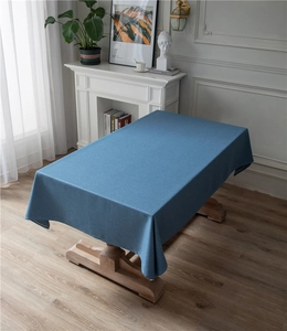 Close-up of blue rectangular tablecloth with thick linen texture and soft draping effect