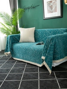 Detail of dark teal chenille sofa cover with geometric lines and cream lace trim