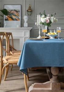 Detailed close-up of navy blue linen-textured tablecloth on a vintage wooden table