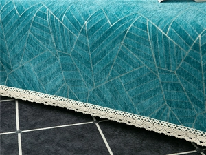 Close-up of thick chenille sofa cover featuring geometric patterns and white lace edges
