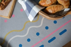 Close-up of thick gray tablecloth with modern geometric prints and texture detail