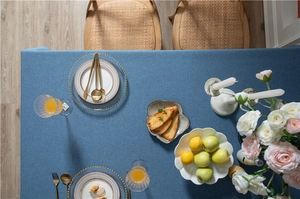 Close-up of blue linen-textured tablecloth with elegant twill weave and drape
