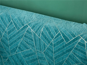 Detail of teal chenille fabric featuring silver geometric triangle patterns and twill texture