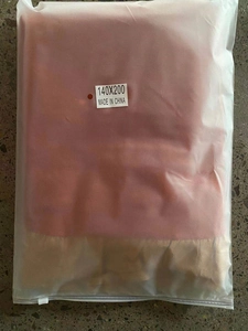 Folded floral cotton tablecloth in frosted zipper packaging with 140x200 size label