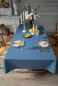 Detailed texture of blue rectangle faux linen tablecloth on a rectangle dining table