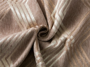 Close-up of thick chenille fabric with brown geometric diamond pattern and soft texture