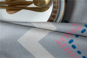 Detailed texture of thick grey cotton linen tablecloth with modern geometric print and cutlery