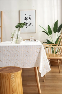 Close-up of yellow and orange polka dot jacquard pattern on high-quality white cotton tablecloth