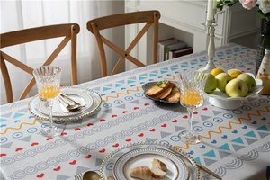 Close-up of modern geometric printed tablecloth with vibrant blue and yellow patterns