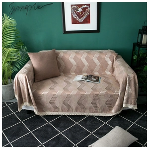 Thick chenille sofa cover with geometric pattern and white lace trim on a modern couch