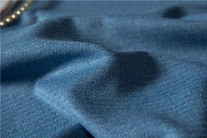 Macro shot of blue herringbone textured thick fabric for minimalist modern tablecloths