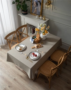 Close-up of grey-brown linen blend tablecloth showing natural texture and drape on wood table