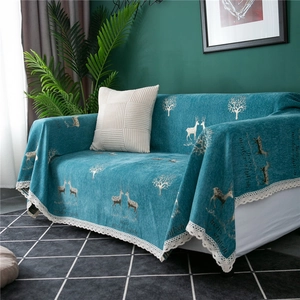 Detail of chenille sofa cover showing deer pattern and white crochet lace edges