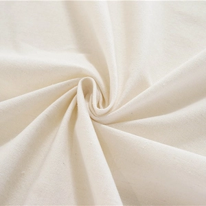 Thick white cotton linen tablecloth with woven texture and elegant tassel ball edges