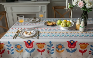 Close-up of bohemian linen tablecloth featuring colorful tulip prints and geometric patterns