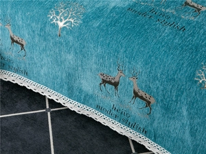Close-up of blue chenille fabric featuring deer prints and delicate white lace edges