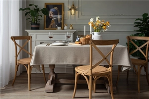Detail of beige faux linen tablecloth showing thick woven texture and clean stitched edges