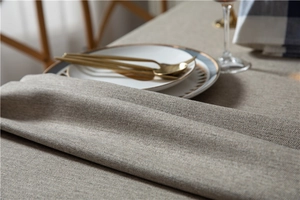 Close-up of thick herringbone weave texture on a beige faux linen tablecloth detail