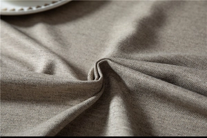 Detail of light brown herringbone fabric showing soft texture and high-quality weaving