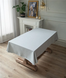 Macro detail of thick faux linen tablecloth with light gray texture and soft drape