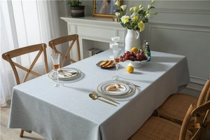Detailed view of grey woven linen texture tablecloth with elegant draping on dining table