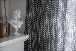 Detail of dark grey herringbone curtain fabric with modern minimalist texture